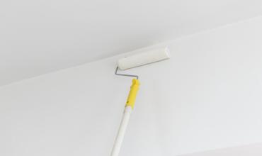 3 Unexpected Things That Decrease Your Home Value a person painting a ceiling
