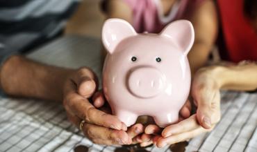What is a Reverse Mortgage? Couple holding a piggy bank