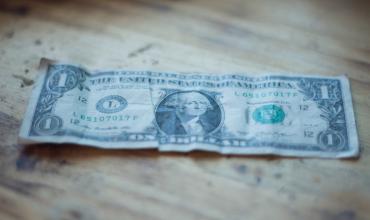Contingencies You Should Always Keep in Your Contract (and Why) a crumpled up dollar bill