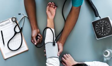 Housing Impacts Heath Outcomes a nurse checking blood pressure