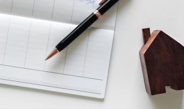 Short Sale FAQ keys beside a checkbook