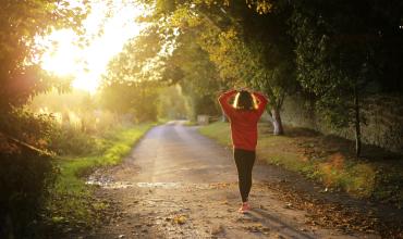 Foreclosures Hurt Homeowners' Health Woman walking on a greenway with hands on her head