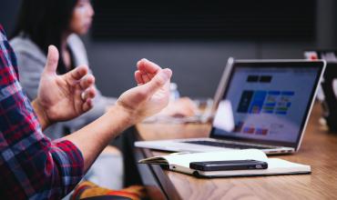 Data Released on Need for Affordable Housing Preservation People sitting at a desk looking at a computer and talking with their hands