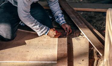 Notice of Funds Available for the Essential Single-Family Rehabilitation Loan Program a man measuring wood