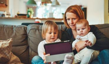 Housing Quality Impacts Childhood Asthma mom and two kids looking at a tablet
