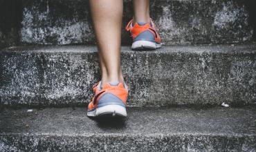 4 Tips to Sell Your Home Fast (So You Can Move Up!) feet running up a flight of stairs