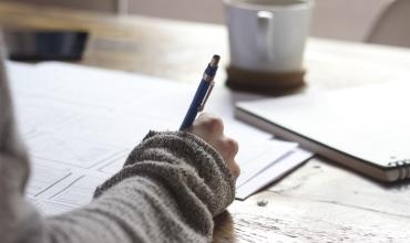 New Report Shows Affordability Gap Still Significant for Renters a person writing notes