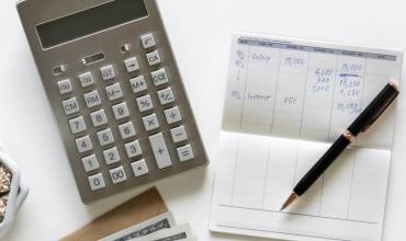 What to Expect When You Make an Offer a calculator and checkbook on a table