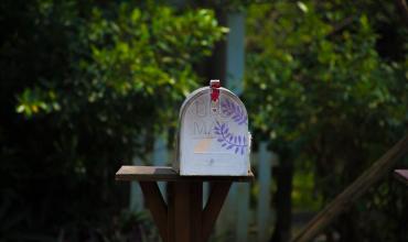 Housing Identified as a Primary Health Impact a mailbox with greenery around it