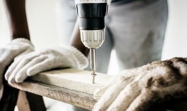 a construction worker using a drill