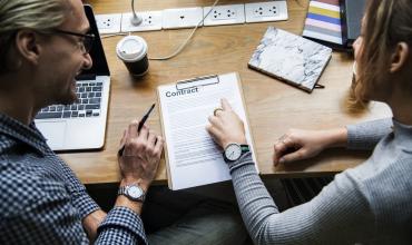 3 Signs You Should Walk Away From the Negotiating Table People talking at a table looking at papers