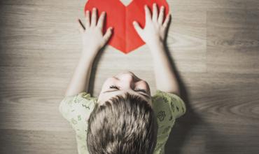 How to Build a Home Disaster Emergency Kit child holding a red paper heart