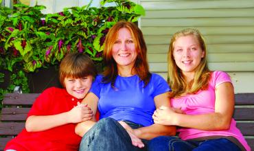 Top 3 Financial Reasons to Buy Instead of Rent in 2017 a smiling mother with her children, sitting on a bench