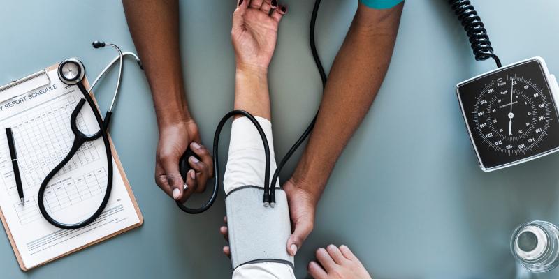 Housing Impacts Heath Outcomes a nurse checking blood pressure