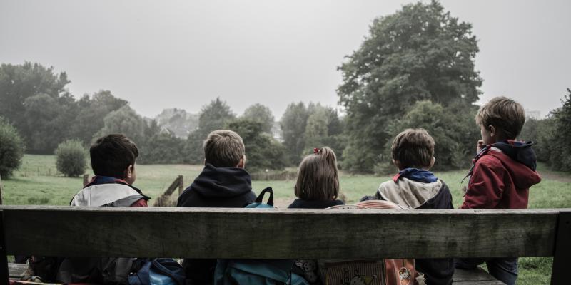Nationwide Data Maps Out Where Poor Children Have the Best Chance to Get Ahead Four children sitting on a bench with their backs to the photographer