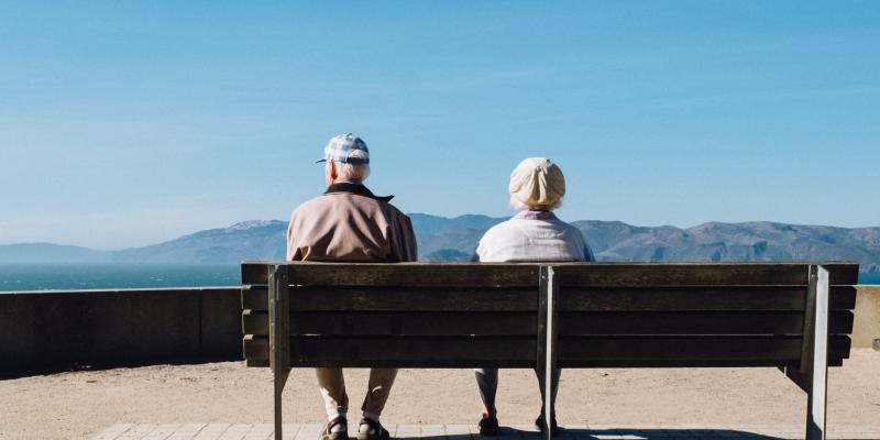 New Report Highlights Boomers’ Housing Affordability Struggle Older couple sitting on a bench facing mountains
