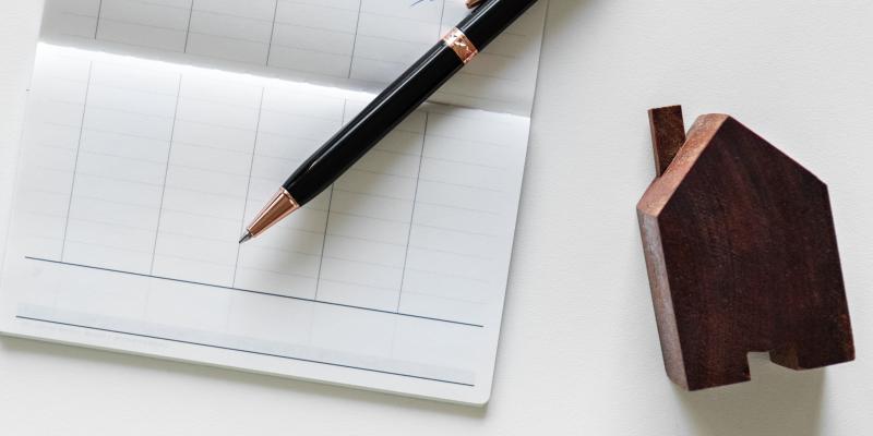 Short Sale FAQ keys beside a checkbook