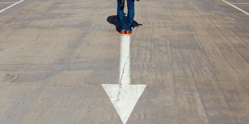 a new report examines ties between housing and health inequities a person standing on a street with an arrow in it