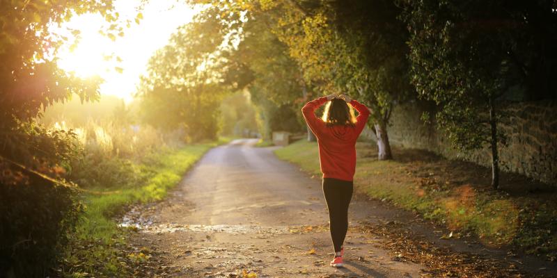 Foreclosures Hurt Homeowners' Health Woman walking on a greenway with hands on her head