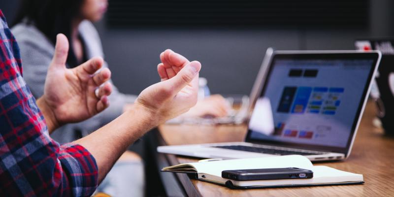 Data Released on Need for Affordable Housing Preservation People sitting at a desk looking at a computer and talking with their hands