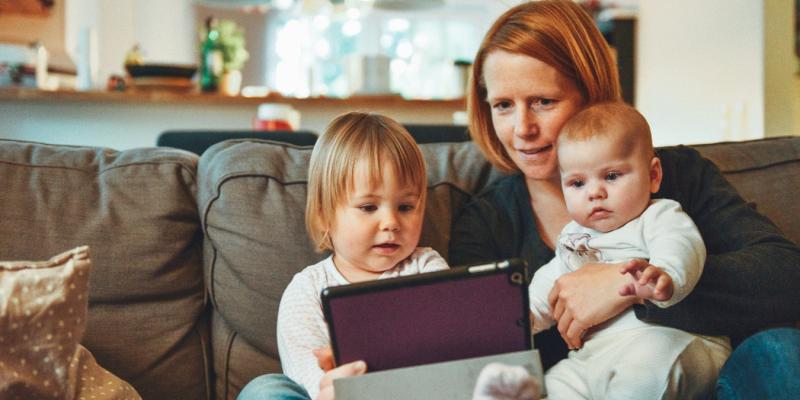 Housing Quality Impacts Childhood Asthma mom and two kids looking at a tablet