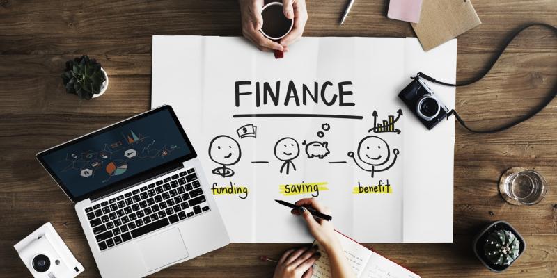 Home Finance Vocabulary for First-Time Buyers hands and a computer working on financial papers