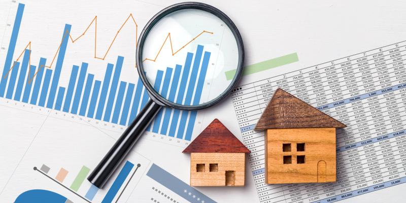 Homeowners Falling Behind in Pandemic Economy Two little wooden houses and a magnifying glass over papers with graphs and charts on them