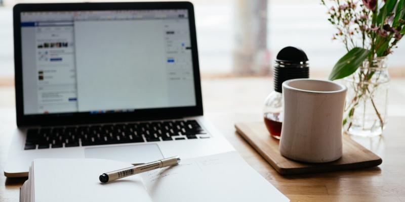 Home Finance Vocabulary for First-Time Buyers a table with a computer, journal and coffee