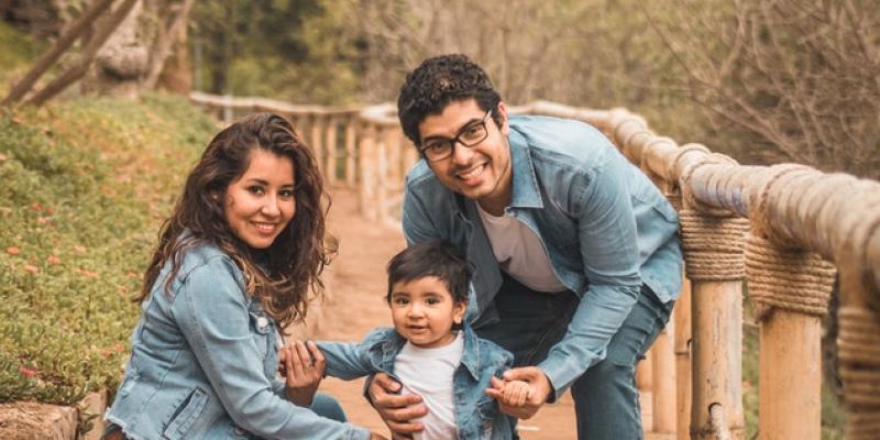 New Study Shows High Housing Cost Threatens Childhood Well-Being A family posing outside