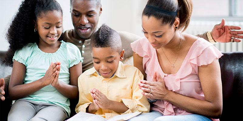 Home Ownership Impacts Children’s Economic Futures family of four reading together