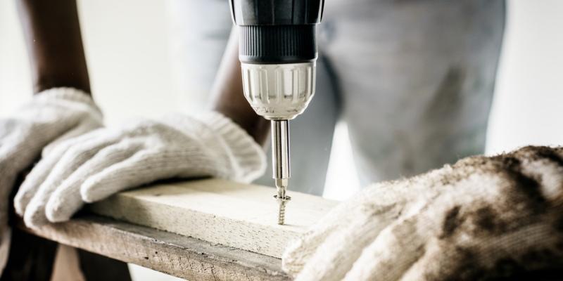 How to Prepare Your Home for a Hurricane construction worker using a power drill