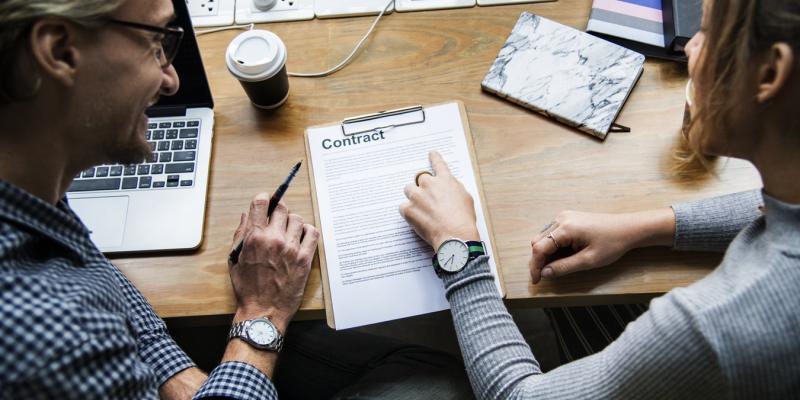 3 Signs You Should Walk Away From the Negotiating Table People talking at a table looking at papers