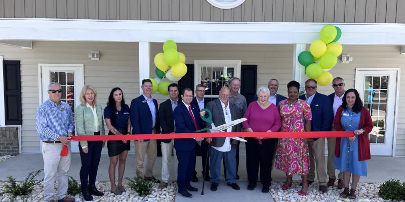 Group of people cutting a ribbon