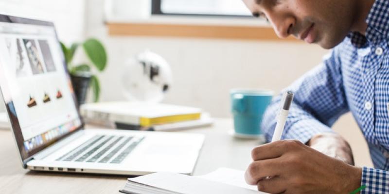 New Household Pulse Survey Shows Many Renters in Dire Straits Man sitting in front of computer writing in a journal