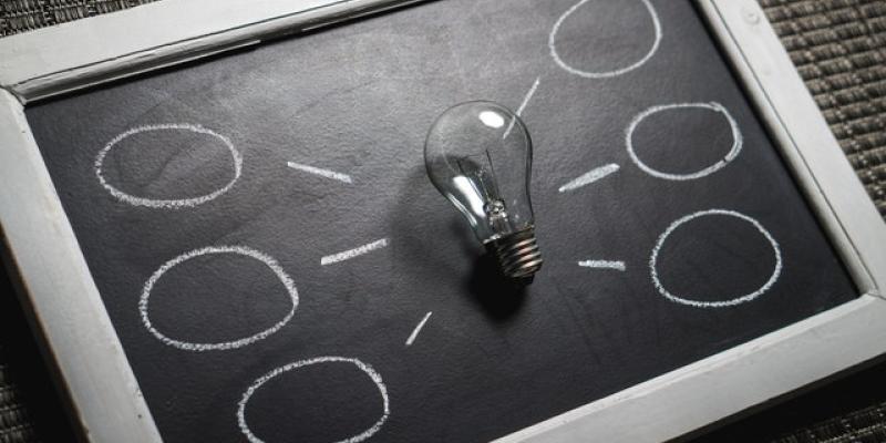 New Housing Found in Former Hotels Lightbulb laying on a chalkboard