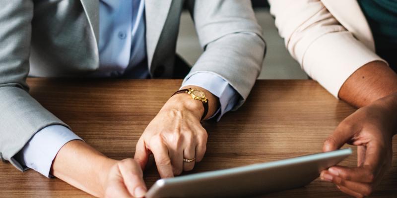 How a Housing Counselor Can Help You Become a Successful Homeowner Two people looking at an iPad